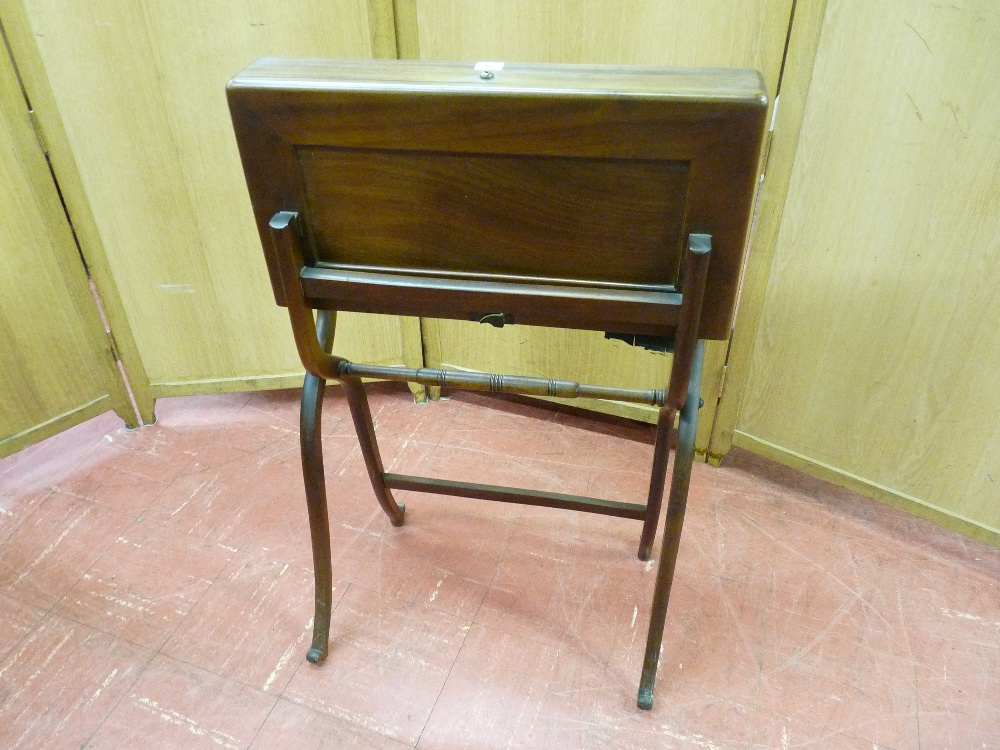 A FOLDING MAHOGANY CAMPAIGN STYLE DESK with fitted interior, the lower section 'X' framed when open,
