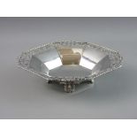 A SILVER FOUR FOOTED BOWL with segmented interior, pierced rim and rope twist edge, Birmingham 1931,