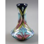 A MOORCROFT POTTERY FLORAL DECORATED VASE, 10 cms high, factory marks to the base, dated 2000