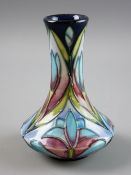 A MOORCROFT POTTERY FLORAL DECORATED VASE, 10 cms high, factory marks to the base, dated 2000