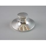 A SILVER CAPSTAN SHAPED INKWELL, 12.5 cms diameter base, 6.5 cms high (no interior liner)