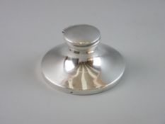 A SILVER CAPSTAN SHAPED INKWELL, 12.5 cms diameter base, 6.5 cms high (no interior liner)