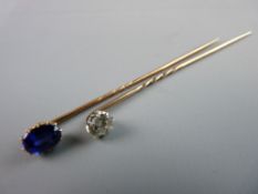 A GOLD TWIST STICK PIN with diamond, estimated 0.5 carat and another gold twist stick pin with