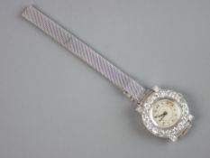 A LADY'S EIGHTEEN CARAT WHITE GOLD CIRCULAR DIAL COCKTAIL WRISTWATCH, the dial having eighteen