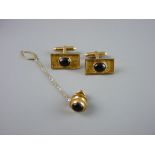 A PAIR OF BOXED, BELIEVED GOLD EASTERN CUFFLINKS of oblong bark form with centre cabochon sapphire