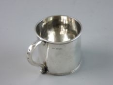 A SILVER DRINKING CUP with banded rims and scroll handle, 7 cms high, 7 cms diameter, Birmingham