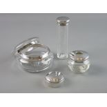 FOUR SILVER DRESSING TABLE ITEMS to include a silver rimmed glass powder bowl and cover, two further