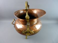 AN ART & CRAFTS STYLE COPPER AND BRASS COAL SCUTTLE with embossed floral pattern, swing handle