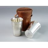 A PAIR OF SILVER BEAKERS by the Goldsmiths & Silversmiths Company in a leather carry case, London