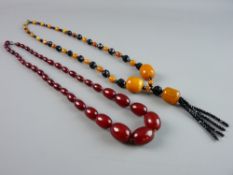 A NECKLACE OF YELLOW AMBER COLOURED AND JET BEADS, the three largest yellow amber coloured stones