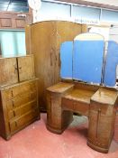 A CIRCA 1930's THREE PIECE OAK BEDROOM SUITE comprising double door wardrobe with carved front