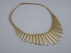 A NINE CARAT GOLD NECKLET in the Egyptian style having plain graduated oblong drops with three bar