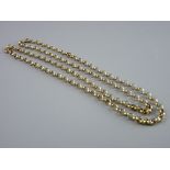 A NINE CARAT GOLD MUFF CHAIN, 70 cms long, 23.9 grms