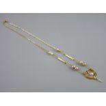 A NINE CARAT GOLD FINE LINK CHAIN with seed pearl drops and heart shaped double strand pendant, 2.