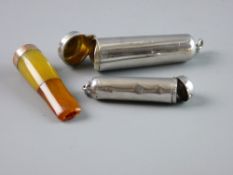 TWO SILVER CIGARETTE HOLDER CASES, one containing a two tone amber holder with nine carat gold rim