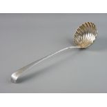 A FINE SILVER SOUP LADLE, the 9 cms bowl of shell form and the tapered handle having feather edgin