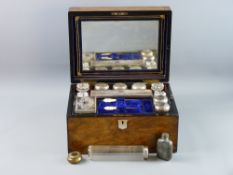 A VICTORIAN WALNUT CASED TRAVELLING VANITY SET, the top with mother of pearl shield cartouche and