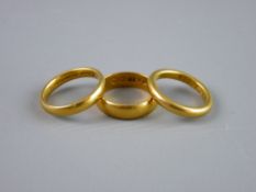 A TWENTY TWO CARAT GOLD WIDE WEDDING BAND and two twenty two carat gold narrow wedding bands, 14.8