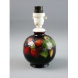 A MOORCROFT 'CLEMATIS' SMALL GLOBULAR LAMP decorated on a cobalt ground, impressed to the base 'Made