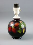 A MOORCROFT 'CLEMATIS' SMALL GLOBULAR LAMP decorated on a cobalt ground, impressed to the base 'Made