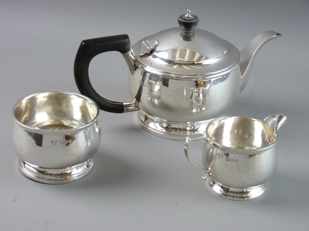 A SILVER THREE PIECE TEASET of plain circular form, London 1933 and 1940, 23 troy ozs