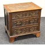 A NINETEENTH CENTURY CARVED OAK CHEST OF DRAWERS having three graduated drawers on bracket feet