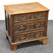A NINETEENTH CENTURY CARVED OAK CHEST OF DRAWERS having three graduated drawers on bracket feet