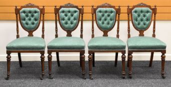 A SET OF FOUR DRAWING ROOM CHAIRS having shield backs with buttoned upholstery and carved rails