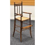 A LATE NINETEENTH CENTURY MAHOGANY CHILD'S HIGH-CHAIR having a footrest and bobbin supports and with