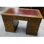 AN ANTIQUE OAK PEDESTAL WRITING DESK having twin pedestals with a bank of three drawers to each