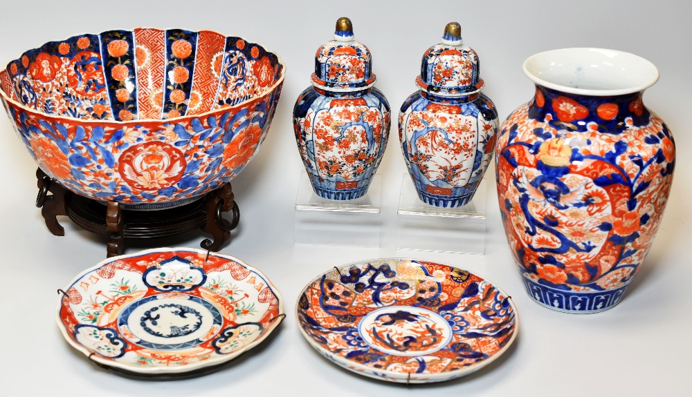 A LARGE IMARI BOWL, VASE & PAIR OF IMARI COVERED VASES & TWO SIMILAR PLATES decorated in the typical