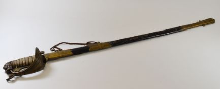 AN ANTIQUE BRITISH NAVAL SWORD & SCABBARD having a lion's head pommel, fish-skin grip with twist