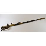 AN ANTIQUE BRITISH NAVAL SWORD & SCABBARD having a lion's head pommel, fish-skin grip with twist