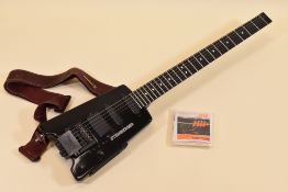 A STEINBERGER ELECTRIC GUITAR in black with carry case, 75cms long