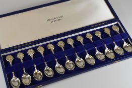 A CASED SET OF TWELVE JOHN PINCHES SILVER SPOONS with medallion terminals bearing astrological
