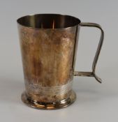 A SILVER MUG of tapered form with ribbed band and handle, 11,2ozs, Sheffield 1945