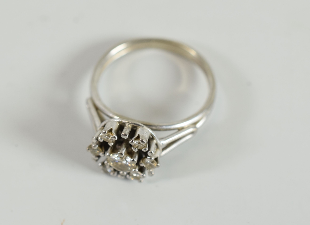 A DIAMOND CLUSTER RING composed of centre diamond and six surrounding stones, in unmarked white - Image 2 of 2