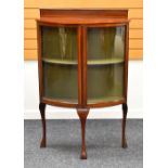 A TWO-DOOR INLAID MAHOGANY BOW FRONT CHINA CABINET on cabriole corner supports and with railback