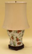 AN ORIENTAL STYLE CERAMIC TABLE LAMP decorated with colourful flowers and insects on white ground,