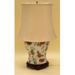 AN ORIENTAL STYLE CERAMIC TABLE LAMP decorated with colourful flowers and insects on white ground,