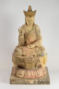 A CARVED BURMESE BUDDHA FIGURE IN MEDITATION POSE with hand raised, on a square base with leaf-