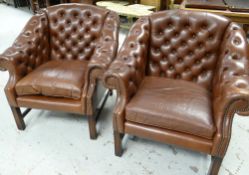 A PAIR OF BUTTONED BROWN LEATHER TUB-STYLE ARMCHAIRS