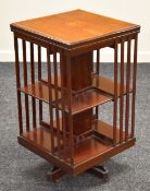 AN INLAID MAHOGANY REVOLVING BOOKCASE of cubic form and having a marquetry cartouche