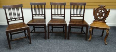 A SET OF FOUR FARMHOUSE CHAIRS AND A CARVED HERALDIC HALL CHAIR