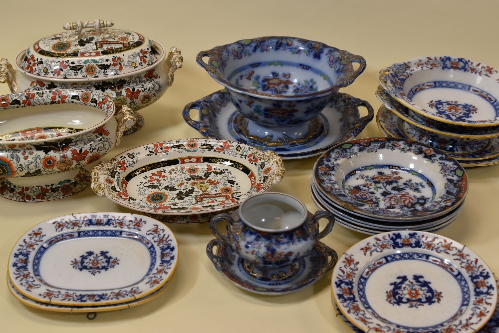 A COLLECTION OF IRONSTONE POTTERY ITEMS including two matching oval tureens (one with lid and stand)