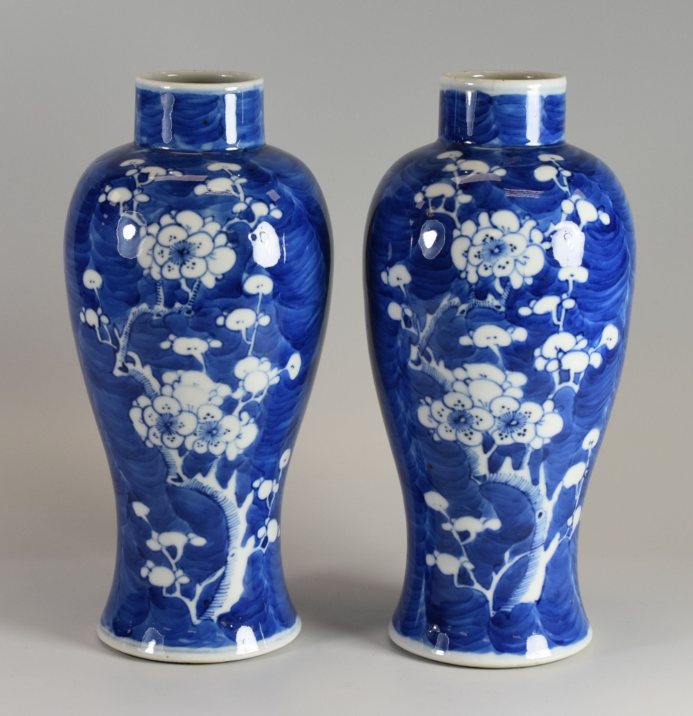 A PAIR OF CHINESE BALUSTER VASES with prunus decoration and with six character marks to the base,