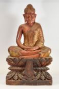 A BURMESE CARVED WOODEN BUDDAH FIGURE seated in double-lotus position on a leaf-form base, 64cms