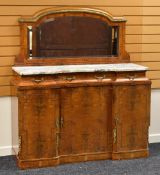 A WALNUT BIEDERMEIER-STYLE WALNUT BREAKFRONT SIDEBOARD having three cupboards below three