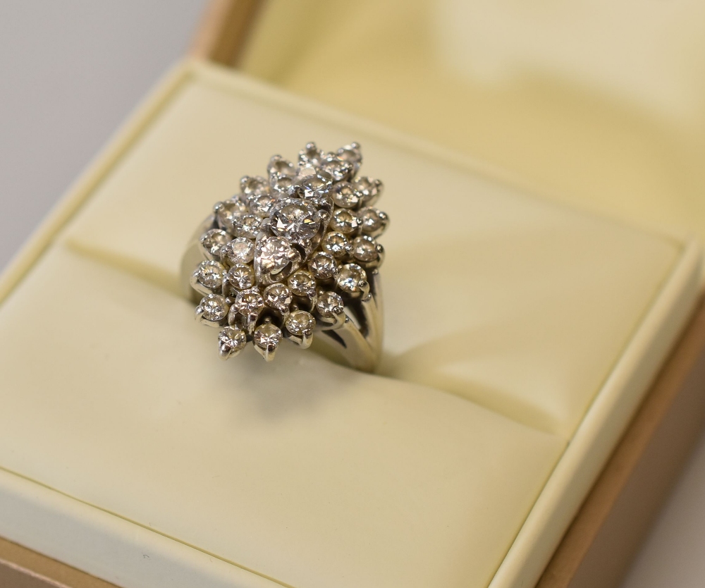 A 14CT WHITE GOLD DIAMOND CLUSTER RING of marquise form with 34 diamonds, 9.3gms