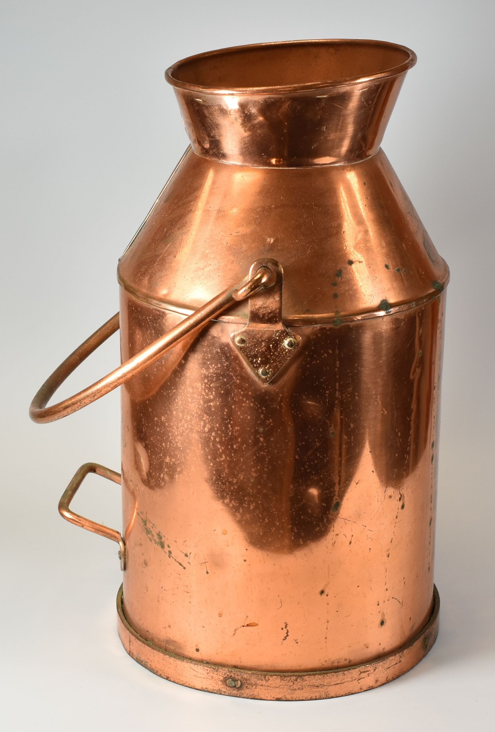 AN ALL COPPER MILK-CHURN of traditional form with swing-handle and lower loop handle, 51cms high